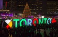 TORONTO, CANADA 12 23 2018: Night view on Nathan Phillips square in the major Canadian city Toronto with people having