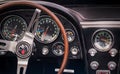TORONTO, CANADA - 08 18 2018: Steering wheel with logo on horn button, dials and knobs on front panel of 1966 Chevrolet Corvette