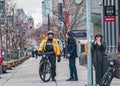 TORONTO, CANADA - 01 04 2020: Toronto Police bicycle patrol officer talking with a man on the University avenue in