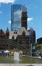 TORONTO, CANADA - 06 27 2016: View across the fountain on Nathan Phillips Square with Old City Hall and Cadillac Fairview Tower in Royalty Free Stock Photo