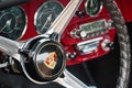 TORONTO, CANADA - 08 18 2018: Steering wheel with logo on horn button, dials and knobs on front panel of 1965 Porsche 356C Ruby Re