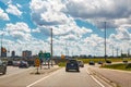 Toronto city highway street with cars traffic during sunny day with white clouds in blue sky. Busy outdoor downtown exit