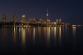 Toronto City skyline at night, clear dark sky, colorful light reflection in the calm water surface of lake Ontario. Royalty Free Stock Photo