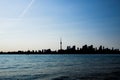 Toronto cityscape with skyscraper, calm lake water. urban skyline silhouette background. blue tone. Royalty Free Stock Photo