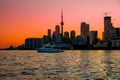 Toronto downtown cityscape with skyscrapers, white yacht and amazing color sunset sky Royalty Free Stock Photo