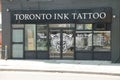 tor, canada - august 1, 2023: toronto ink tattoo parlor store with sign in white and black with street road. p Royalty Free Stock Photo