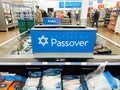 Toronto, Ontario, Canada - April 10, 2022: Happy Passover sign in store grocery shop Walmart. Shelves with food for Jewish spring