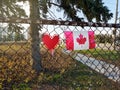 Toronto, Ontario, Canada - April 28, 2020: Red heart and Canadian flag on wire mesh fence outdoor. Thank you message to the