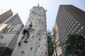 Active woman climbing outdoor rock wall