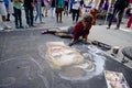 Female artists painting with chalk and pastels on the street of Toronto