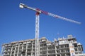 Crane and building construction activity with blue sky background Royalty Free Stock Photo