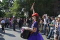 Crowd of multi-ethnic men and woman walking with a drummer on street protest against G-20 meeting in Toronto