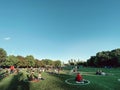 Toronto, Ontario, Canada - June 12, 2020: People sitting in painted circles at Trinity Bellwoods park keeping social distancing.