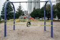 Toronto, Ontario, Canada - March 26, 2020: A closed outdoor playground. Kids play area locked with yellow caution tape to stop