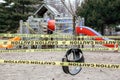 Toronto, Ontario, Canada - March 26, 2020: A closed outdoor playground. Kids play area locked with yellow caution tape to stop