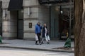 Toronto, Ontario, Canada - March 21 2023 - Couple walks down the street in deep conversation