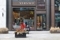 Toronto, Ontario, Canada - March 21 2023 - Man outside Versace store reading a newspaper