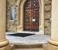 Catholic church door with sign reading all masses cancellation due to COVID-19 Royalty Free Stock Photo
