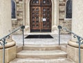 Catholic church door with sign reading all masses cancellation due to COVID-19 Royalty Free Stock Photo