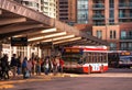 Toronto, Ontario, Canada - 10 03 2022: Passengers at Finch subway station bus terminal lined up in front of red NOVABUS Royalty Free Stock Photo