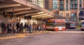 Toronto, Ontario, Canada - 10 03 2022: Passengers at Finch subway station bus terminal lined up in front of red NOVABUS Royalty Free Stock Photo