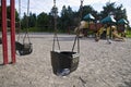 Children play on a public playground with swing and slide Royalty Free Stock Photo