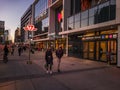 Toronto, Ontario, Canada - 09 23 2022: A young couple walking along Younge Street in front of Sheppard Yonge TTC subway