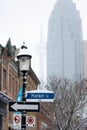 Toronto, Ontario - December 2, 2019 : Market Street sign with the CN Tower seen behind St. Lawrence Market on a cloudy foggy day.