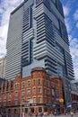 Modern high rise apartment building sprouts out of old one Royalty Free Stock Photo