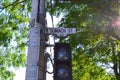 Toronto street sign on large cement pole with lighted crossing warning