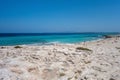 Torquoise color of the water with white sand in sunny day the Ses Illetes beach full of people Royalty Free Stock Photo