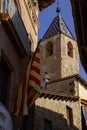 Torre de las horas in Solsona between a catalonia flag