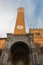 Torre del Mangia, clock tower of a city hall on Piazza del Campo main square in Siena, Tuscany Royalty Free Stock Photo