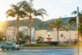 TORREMOLINOS, SPAIN - FEBRUARY 13, 2014: A crossroad with a fountain, palms and flower beds and mountains at the background and