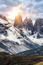 Torres del Paine peaks coming from clouds at sunset times