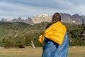 Girl wrapped in blanket with mountains