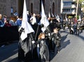 Torrevieja, Spain - April 7, 2023: Group of penitents during Holy Week procession