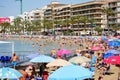 Lot of tourists enjoy warm summer day in the sandy beach of Playa Del Cura Royalty Free Stock Photo