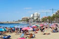 Lot of people sunbath on popular Playa del cura sandy beach of Torrevieja city