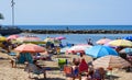 Torrevieja, Spain - June 10, 2019: Lot of people tourists sunbath on popular Playa del cura beach in Torrevieja resort city during