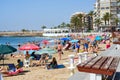 Lot of tourists enjoy warm summer day in the sandy beach of Playa Del Cura Royalty Free Stock Photo