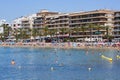 Lot of tourists enjoy warm summer day in the sandy beach of Playa Del Cura Royalty Free Stock Photo