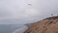 Torrey Pines paragliding flight. Paraglider flying. California ocean coast cliff Royalty Free Stock Photo