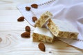 Torrone or white nougat with almonds and napkin on a wooden tab Royalty Free Stock Photo