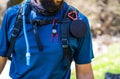 Torso of equipped hiker with speaker, compass and water pipe