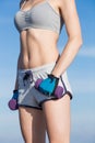 Torso of fitness girl with dumbbells on open air Royalty Free Stock Photo
