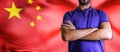 Torso of a man Young man with arms crossed against China states national flag