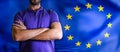 Torso of a man Young man with arms crossed against EU flag