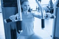 Torso portrait of Cheerful young adult caucasian woman working out on exercise machine inside gym Royalty Free Stock Photo