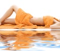 Torso of relaxed lady with orange towels Royalty Free Stock Photo